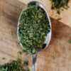 close up photo of green oregano on a spoon